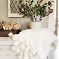 Decorating for fall with pumpkins, florals and chunky blanket.