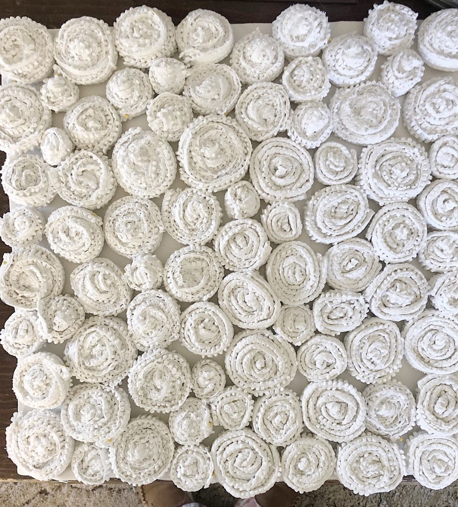 Flower pillow with rosettes
