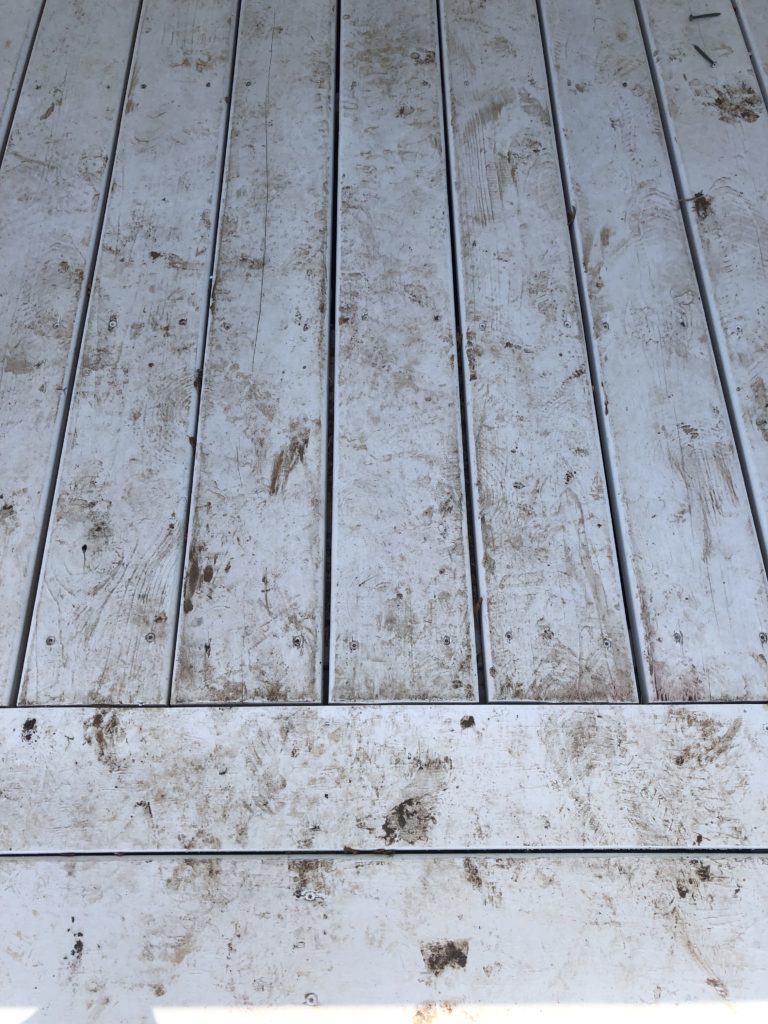 Painted porch floorboards after the rain