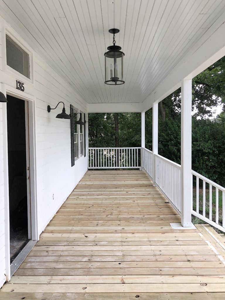 The front porch with unpainted floor boards