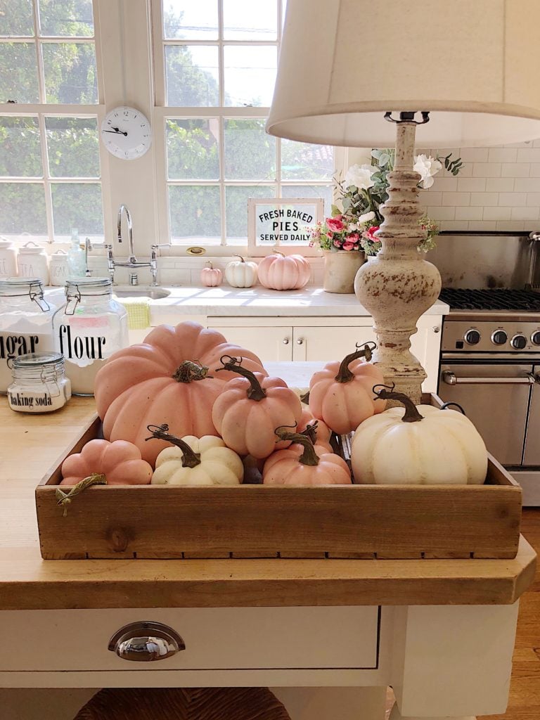 pink pumpkins in a vintage box on the kitchen island