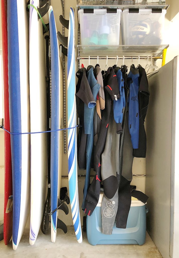 garage makeover with surfboard and wetsuits