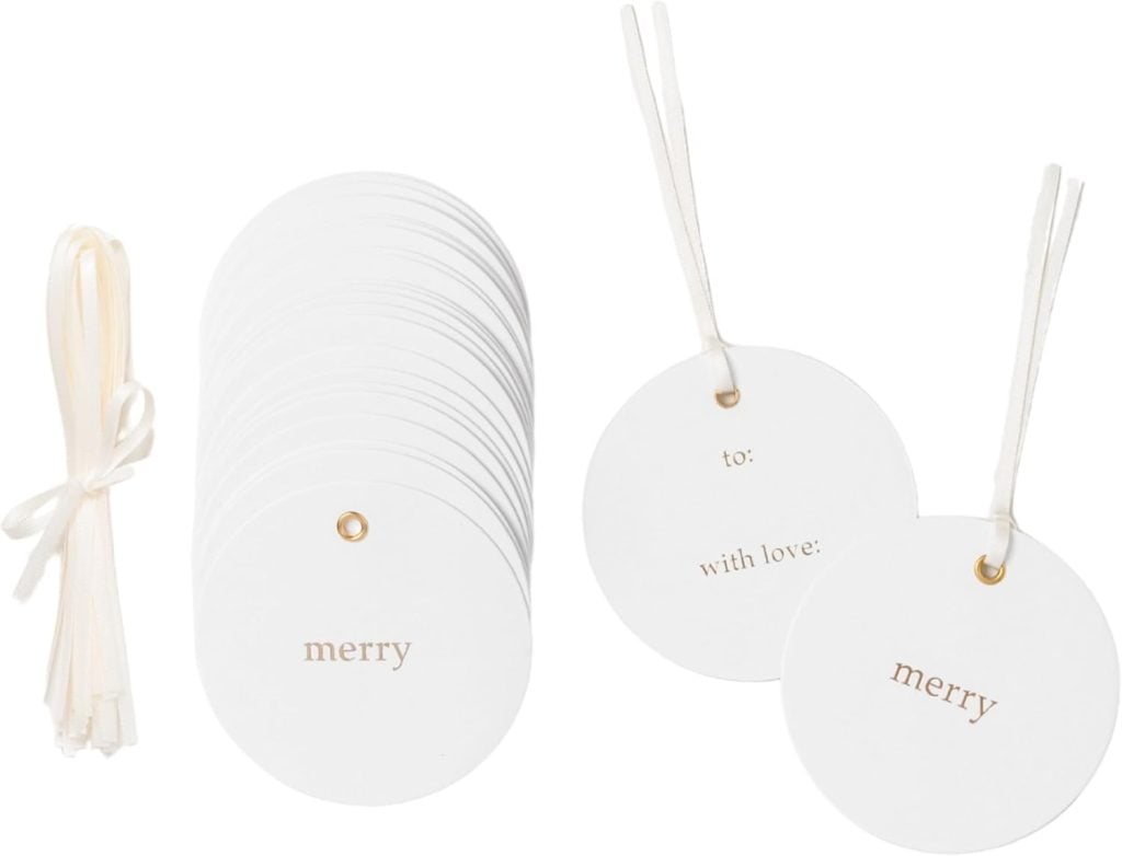 Round white gift tags with "merry" printed in gold, stacked on the left. Perfect for a DIY Christmas gift, two tags are displayed on the right, one showing "to: with love:". Cream-colored strings included.