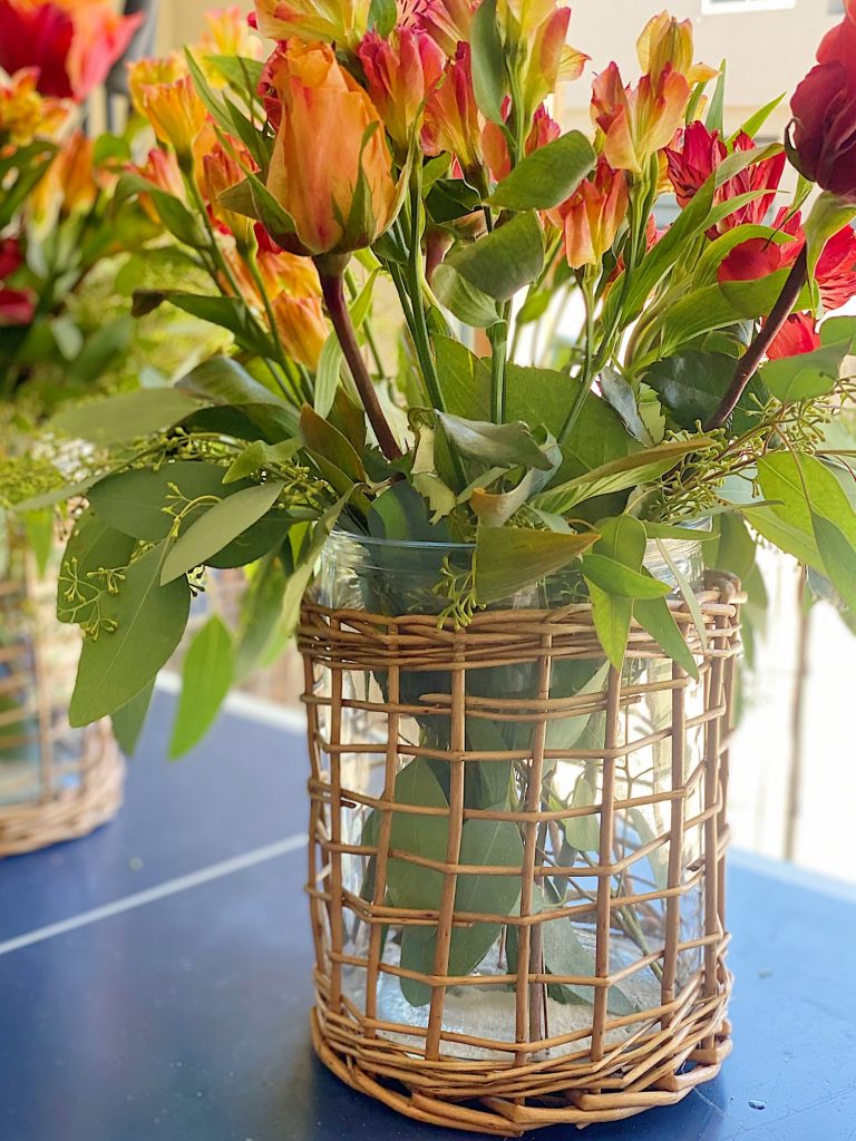 Arranging Flowers in vases for Summer Beach Dinner