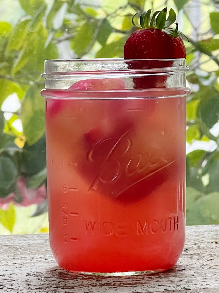 A Cocktail with Frozen Cranberry Roses