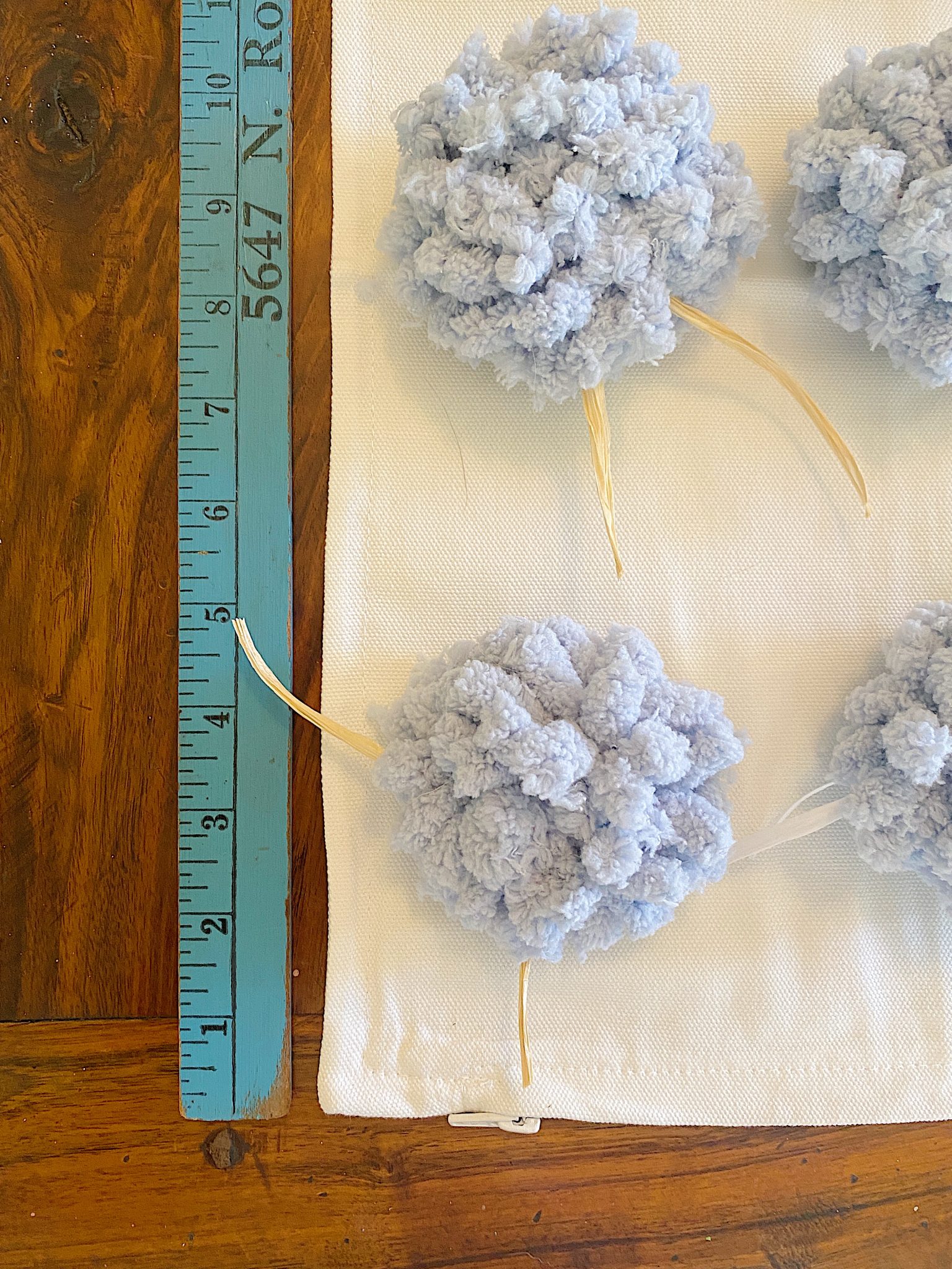 Measuring Pom Poms on a Pillow