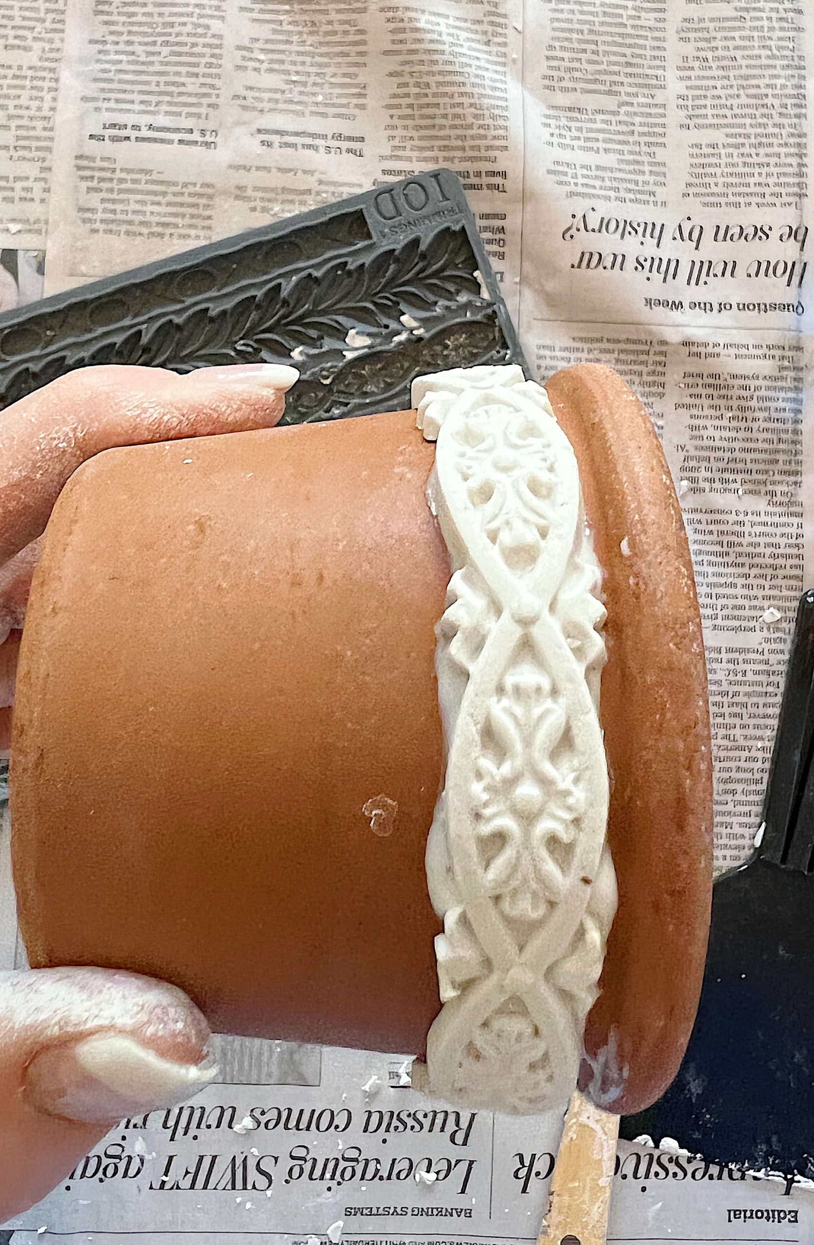 Glueing Clay onto the Terra Cotta Pots