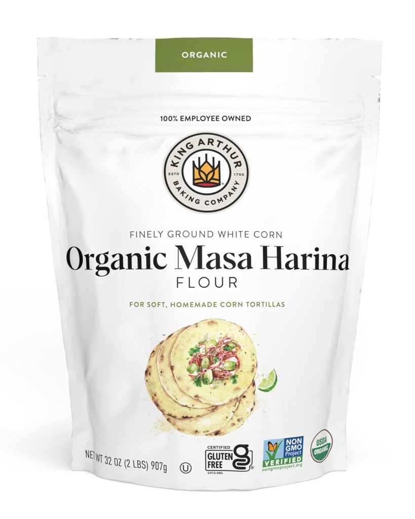 A white 32 oz King Arthur Baking Company bag of organic masa harina flour is shown, featuring tortillas, certification logos, and labeling that it is gluten free and non-GMO—perfect for a happy Taco Tuesday.