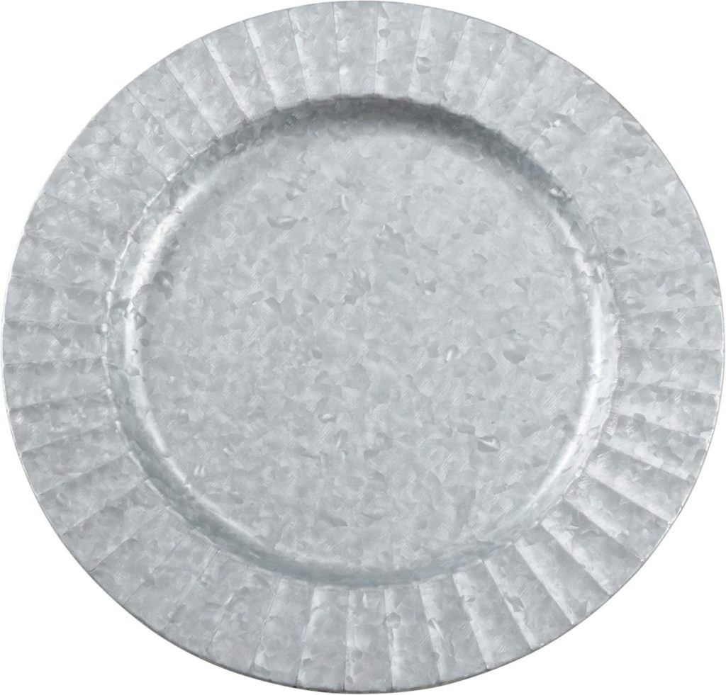 A round, silver-colored galvanized metal plate with a textured, slightly patterned surface and a fluted rim—perfect for adding rustic charm to your outdoor table decor.