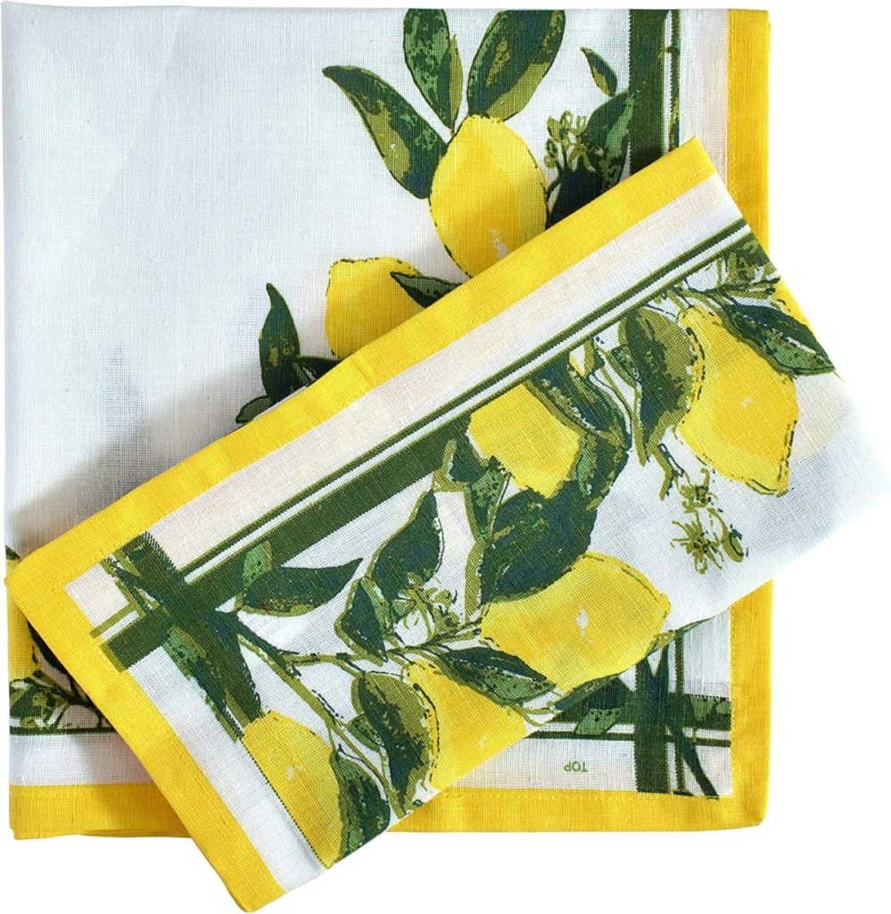 Square white napkin with yellow border and a lemon fruit and leaf print, with a second matching napkin folded on top—perfect for brightening up your outdoor table decor.