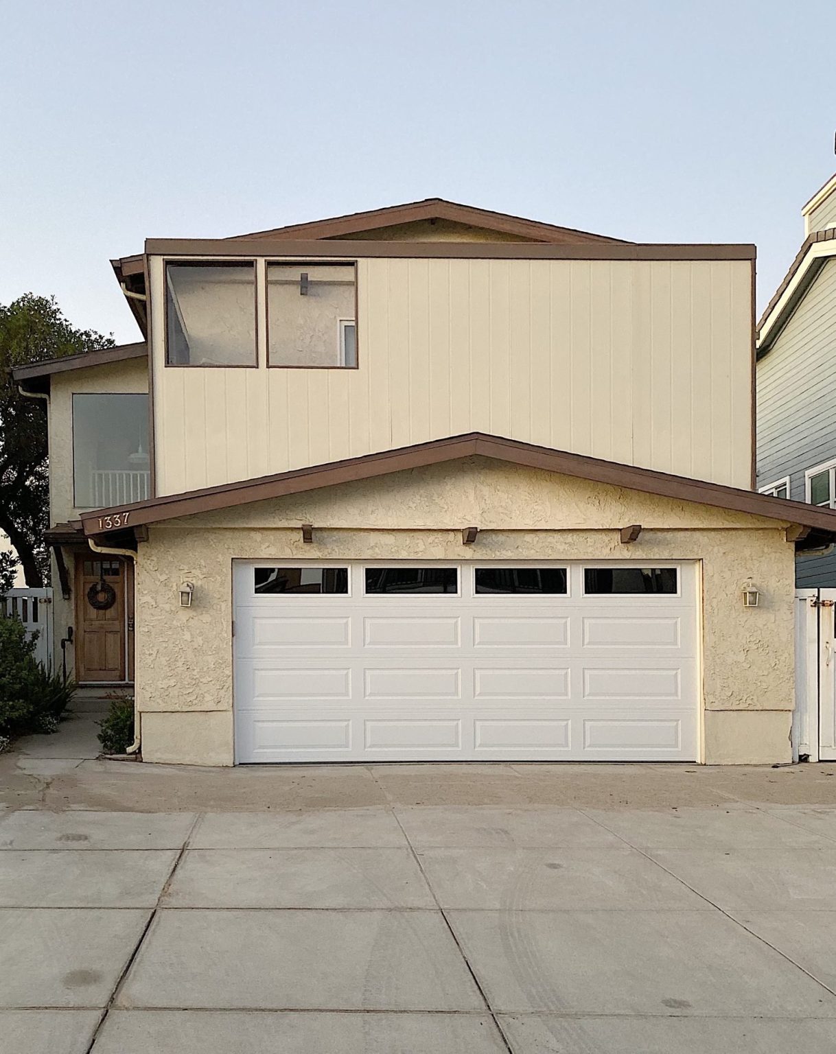 Beach house exterior with sand in driveway