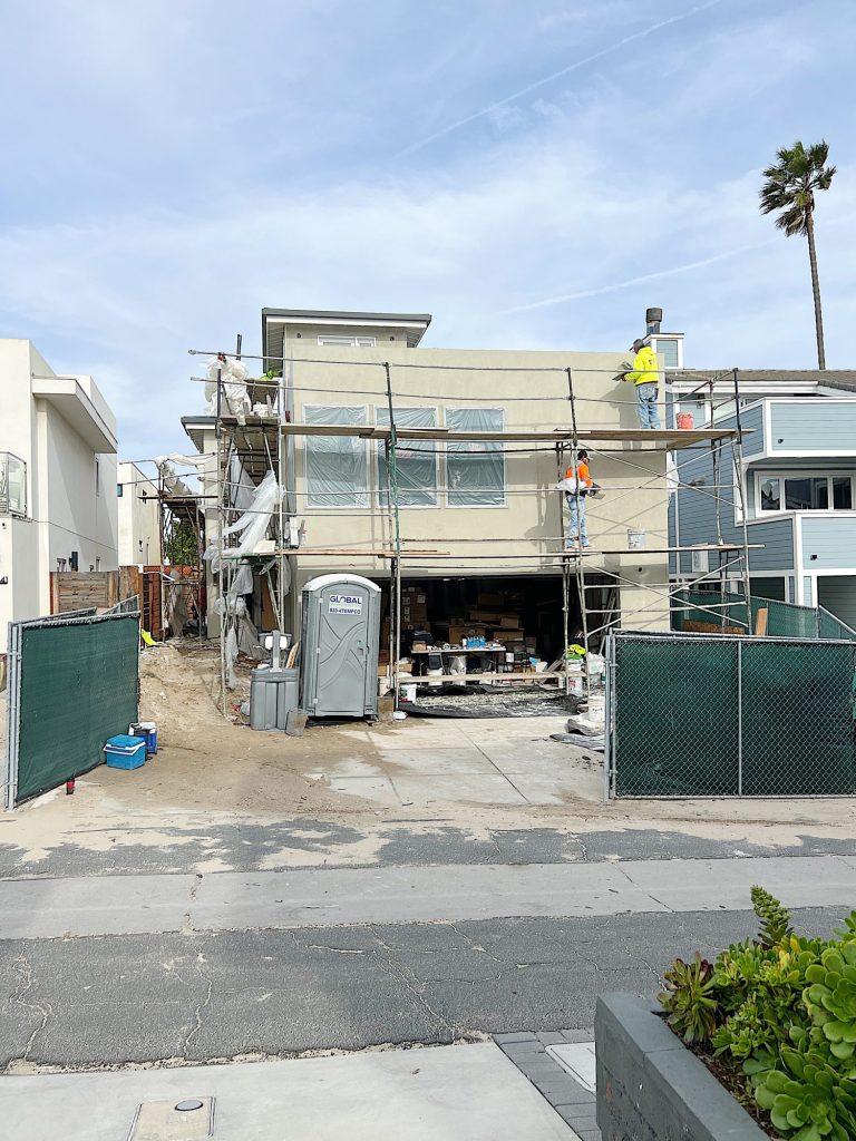 front of the beach house with plaster being added