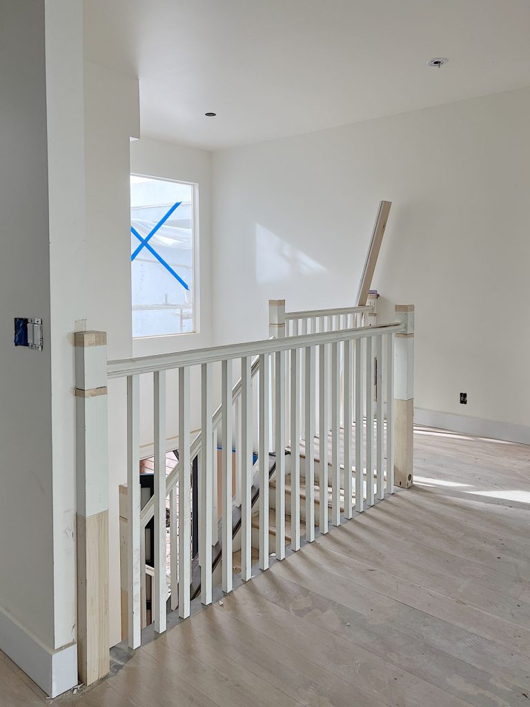 slightly refurbished white staircase in the beach house