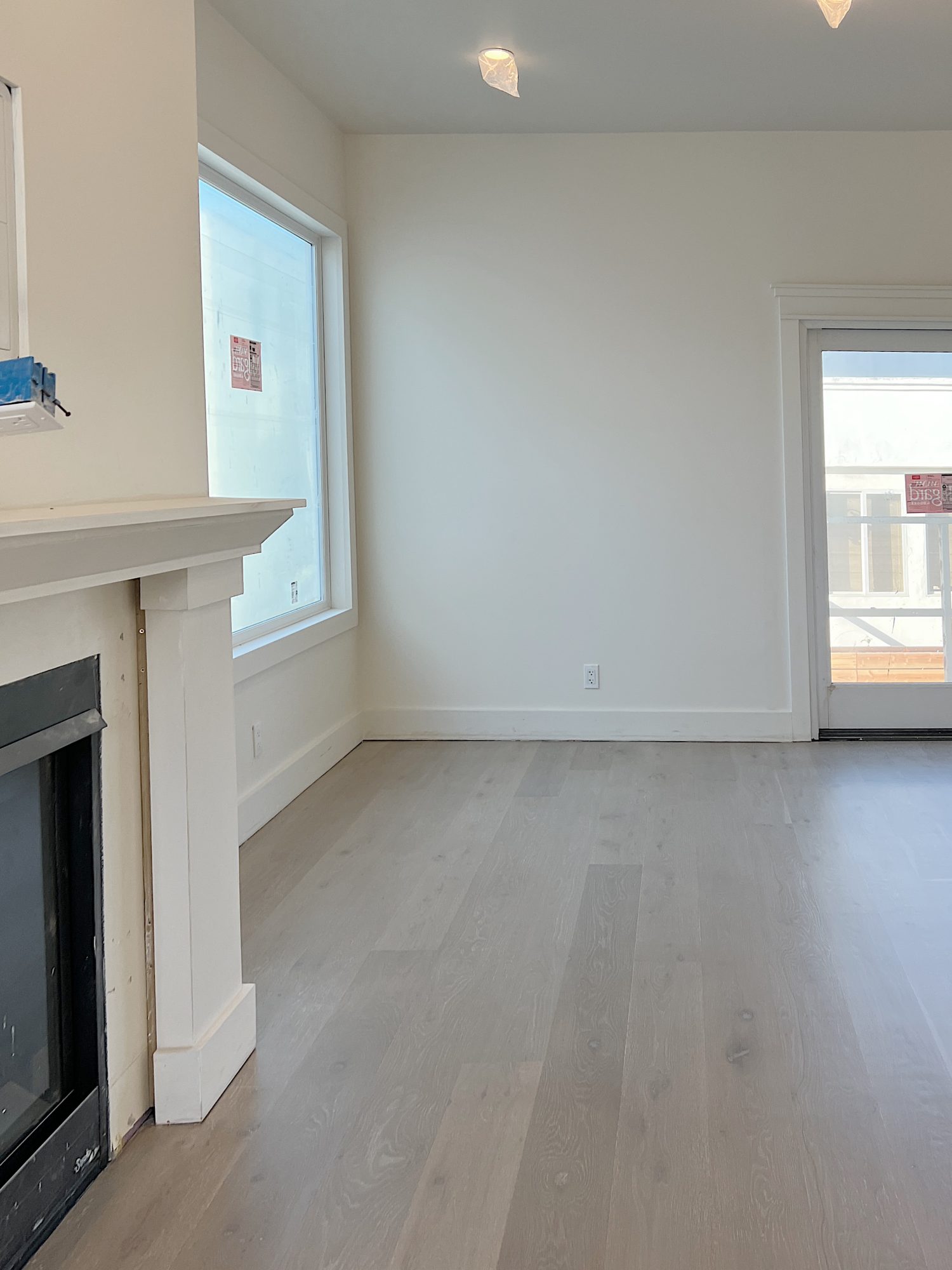 white kitcehn at the beach house with new light wood floors and white cabinets.