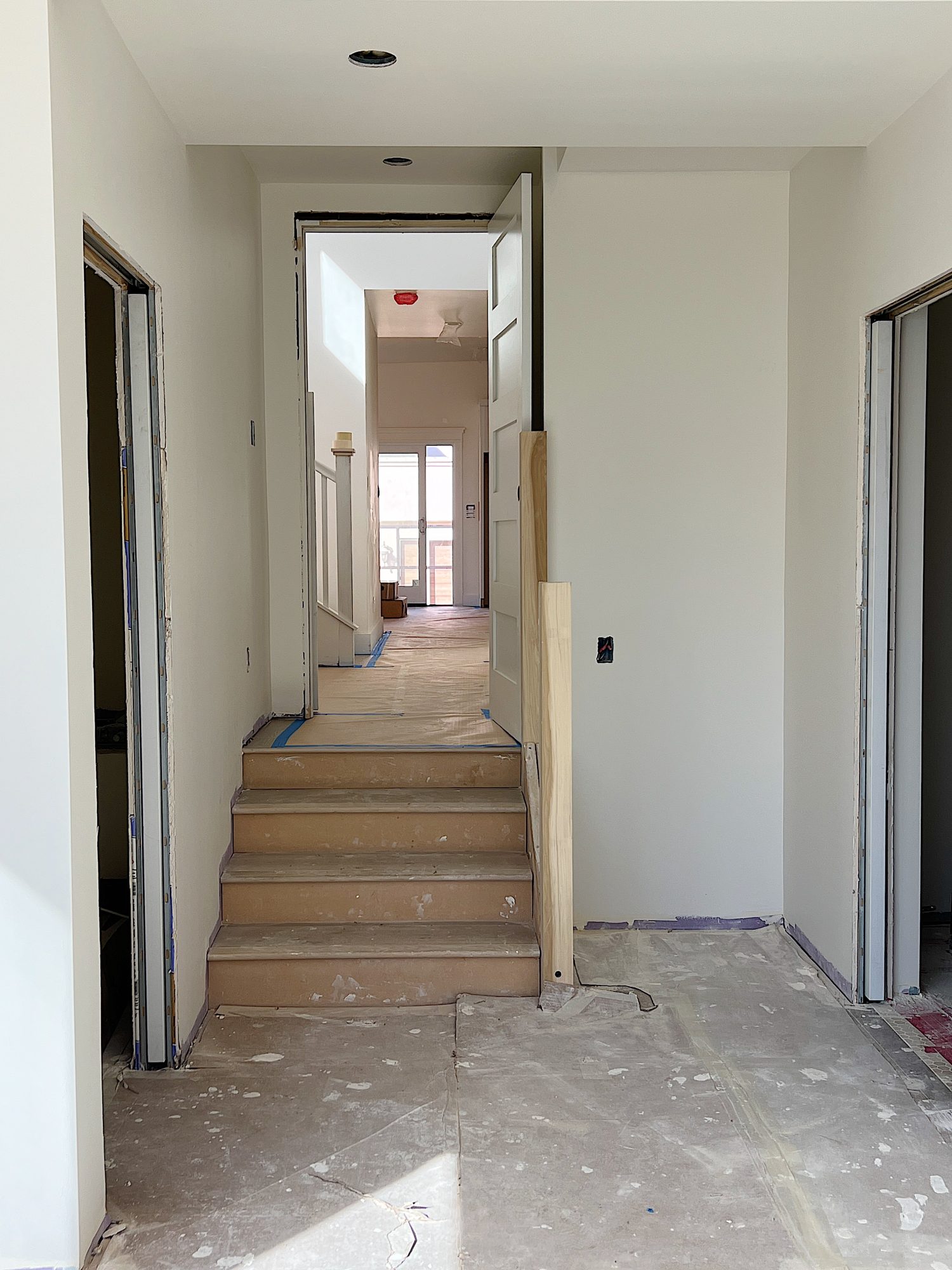 stairs into the primary bedroom looking into the family room