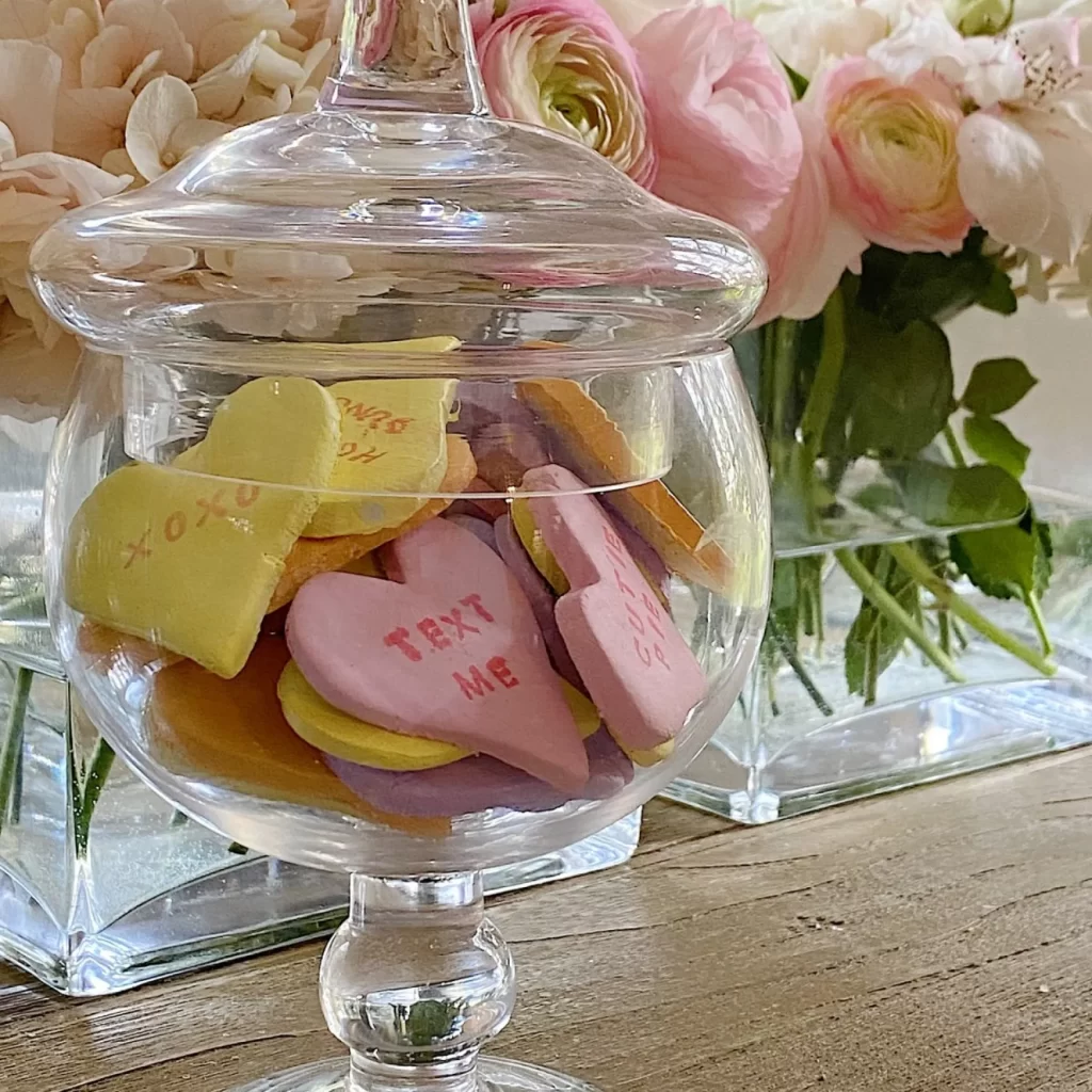 Handmade clay Valentine conversation hearts in a glass apothecary jar.