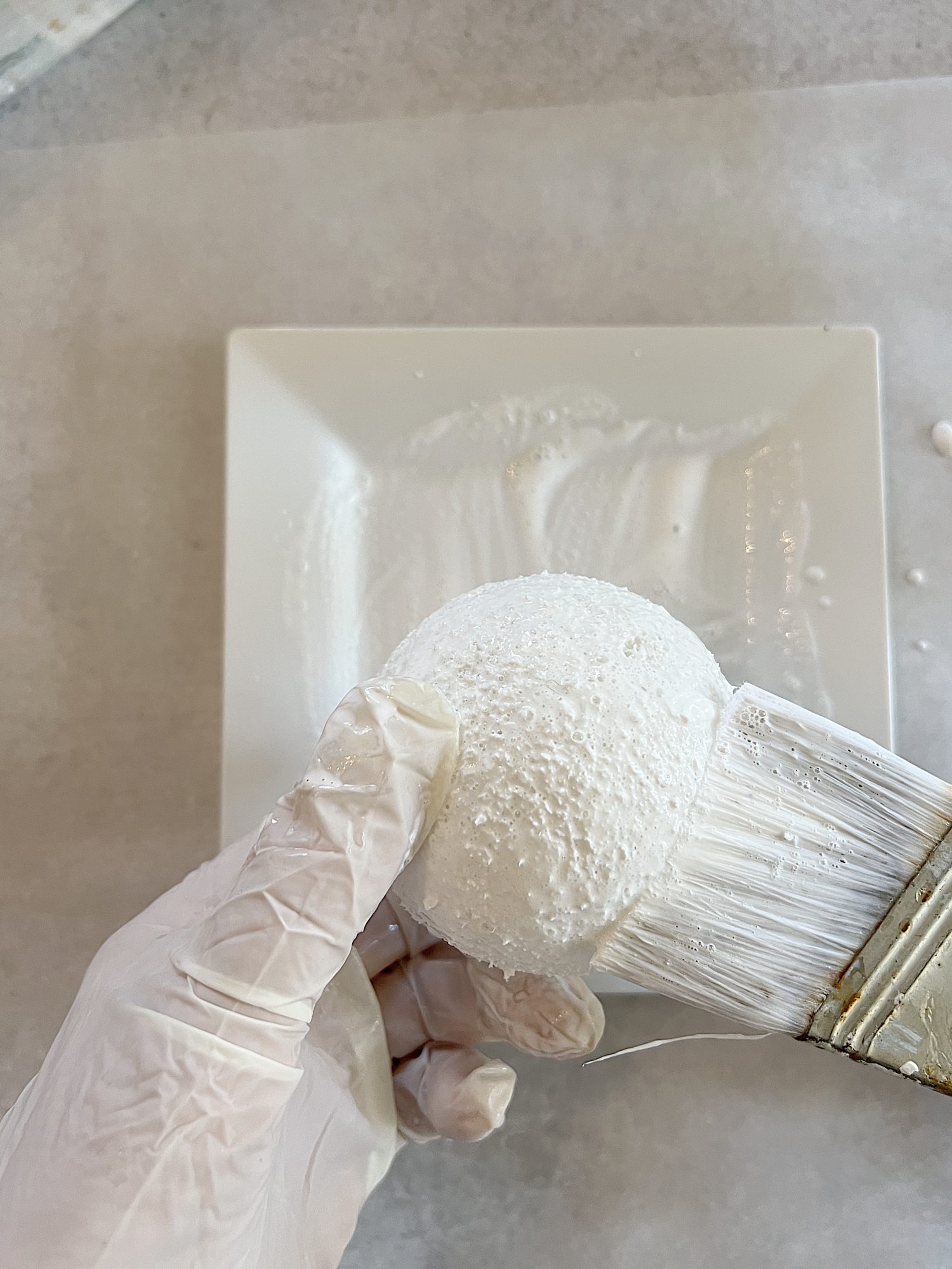 covering small styrofoam balls with mod podge glue