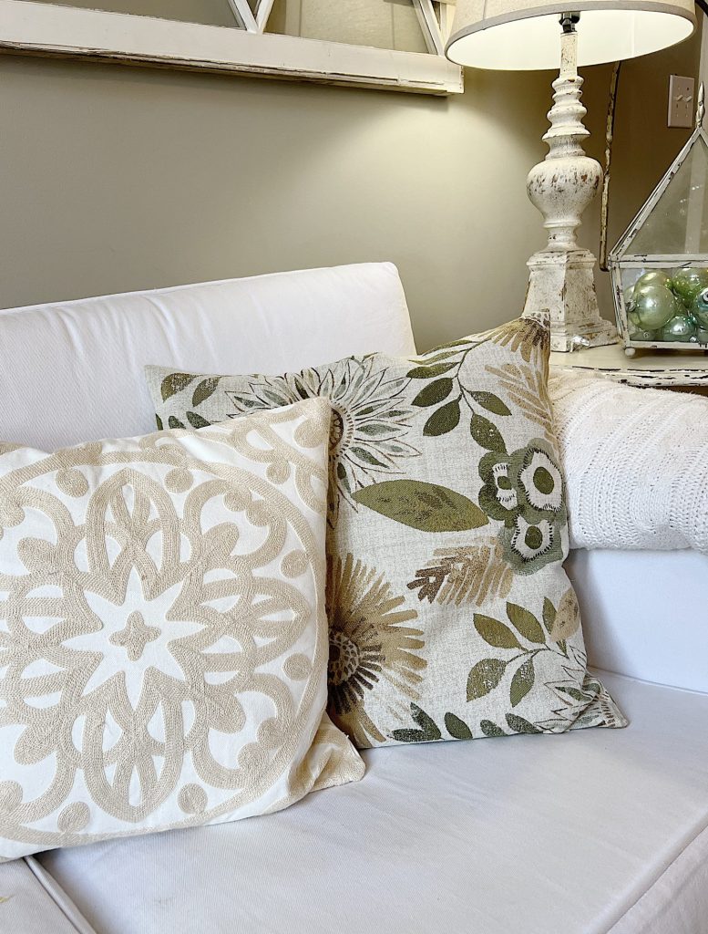 taupe and sage pillows on a white couch