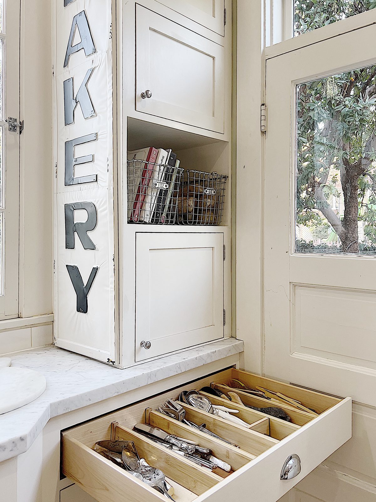 organizing utensil drawer in the kitchen
