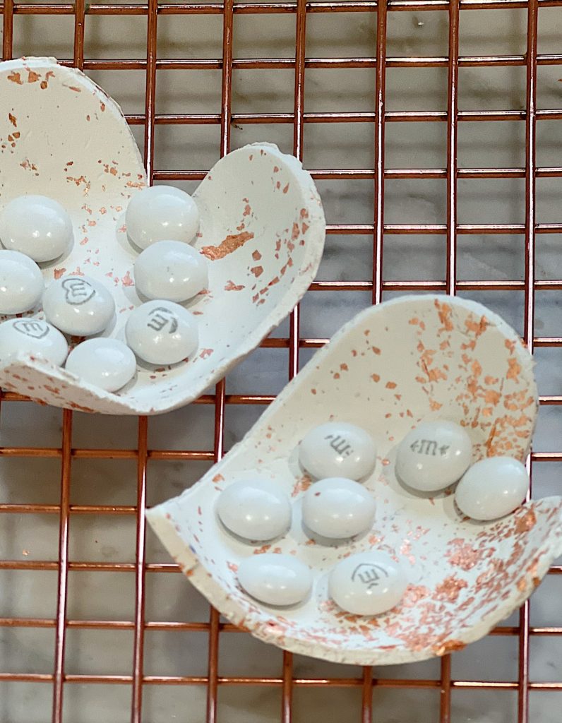 white clay and copper hearts molded into small candy dishes.