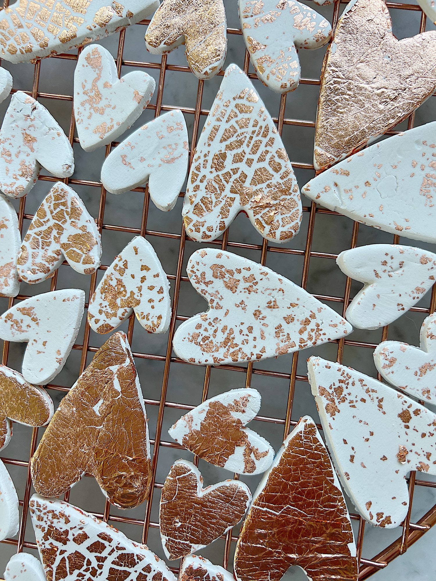 white clay hearts made from air dry clay, copper foil and a heart shaped cookie cutter