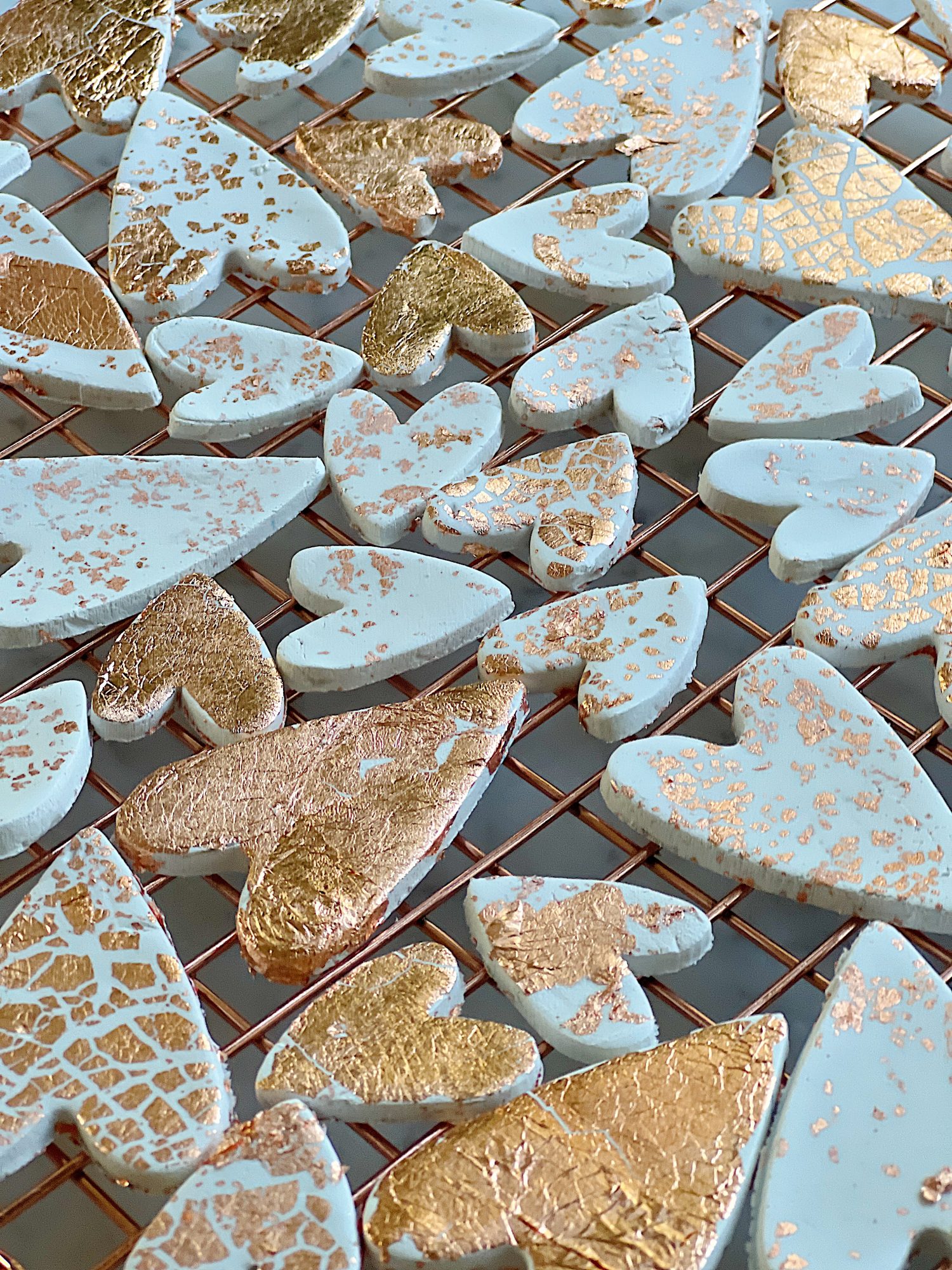 white clay hearts made from air dry clay, copper foil and a heart shaped cookie cutter
