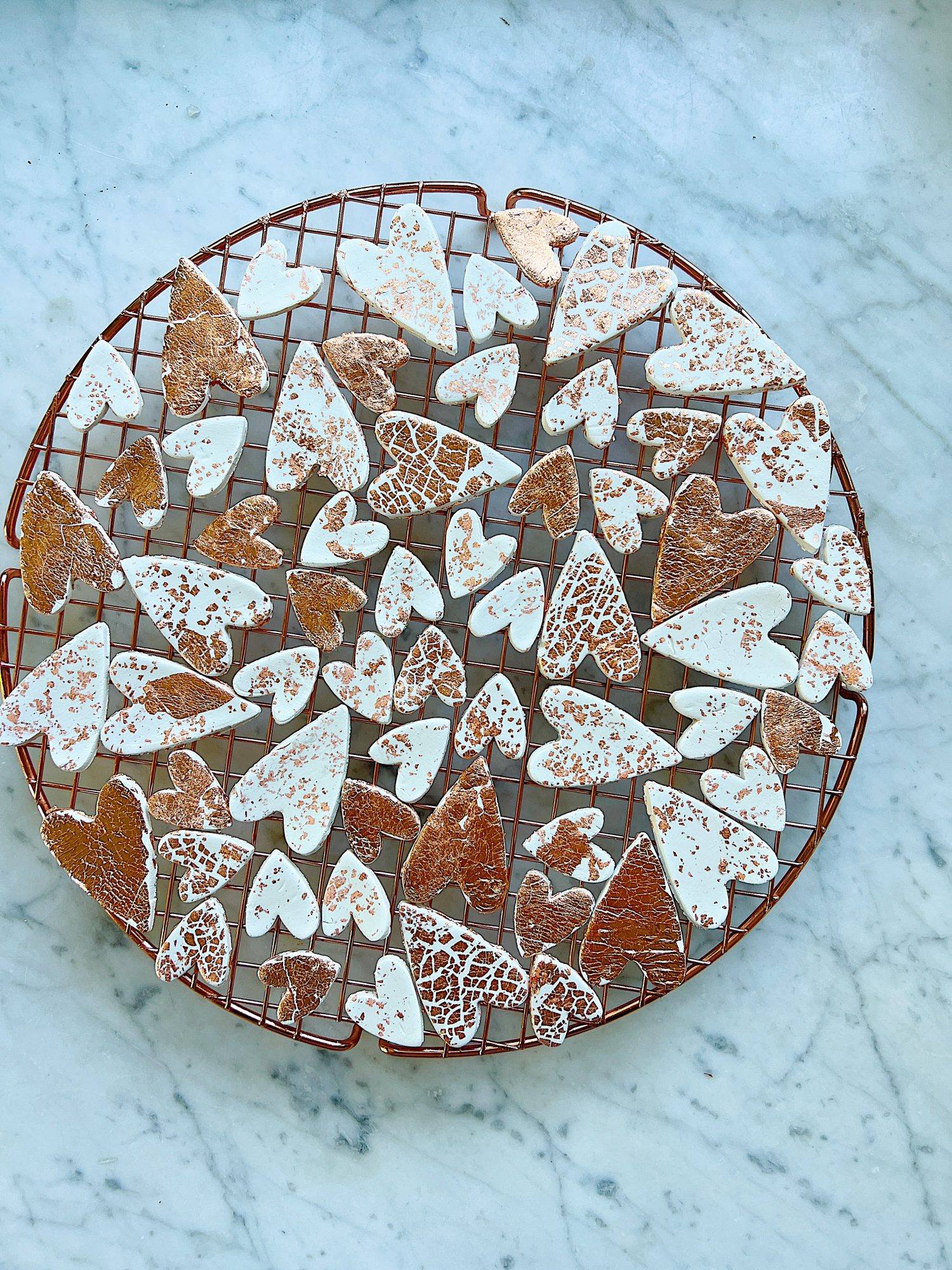 a copper wire tray with white clay hearts made from air dry clay, copper foil and a heart shaped cookie cutter