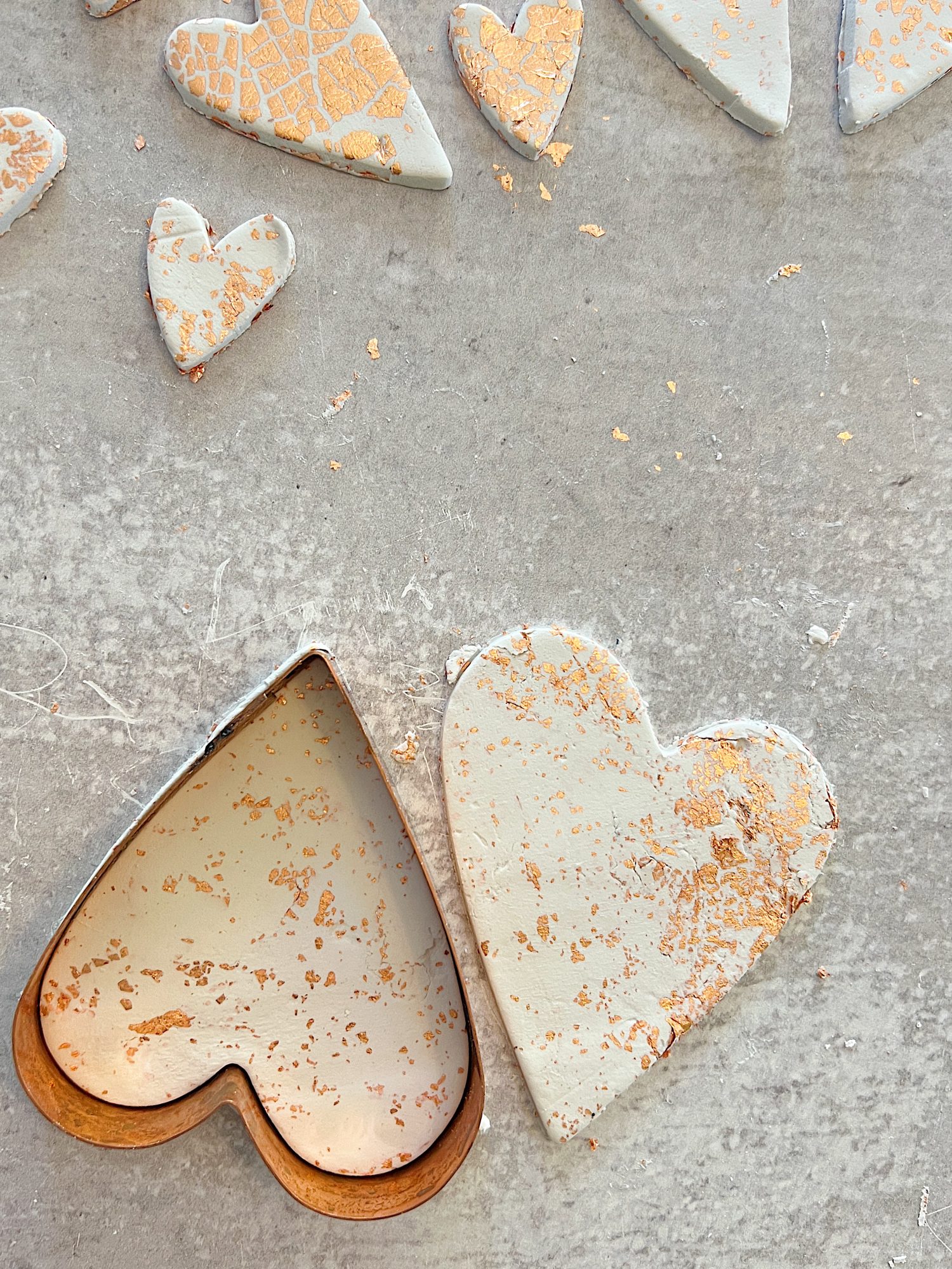 white clay hearts made from air dry clay, copper foil and a heart shaped cookie cutter
