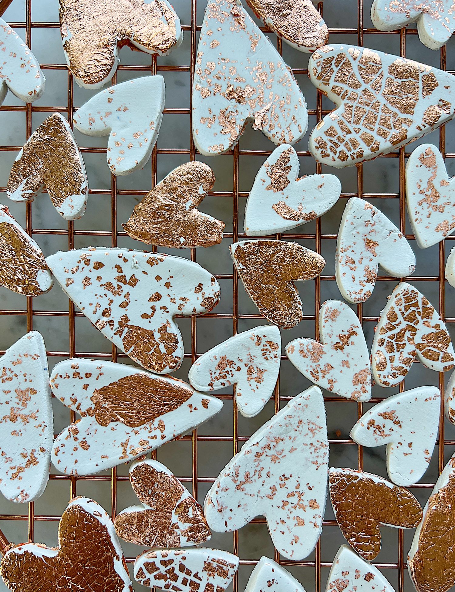white clay hearts made from air dry clay, copper foil and a heart shaped cookie cutter