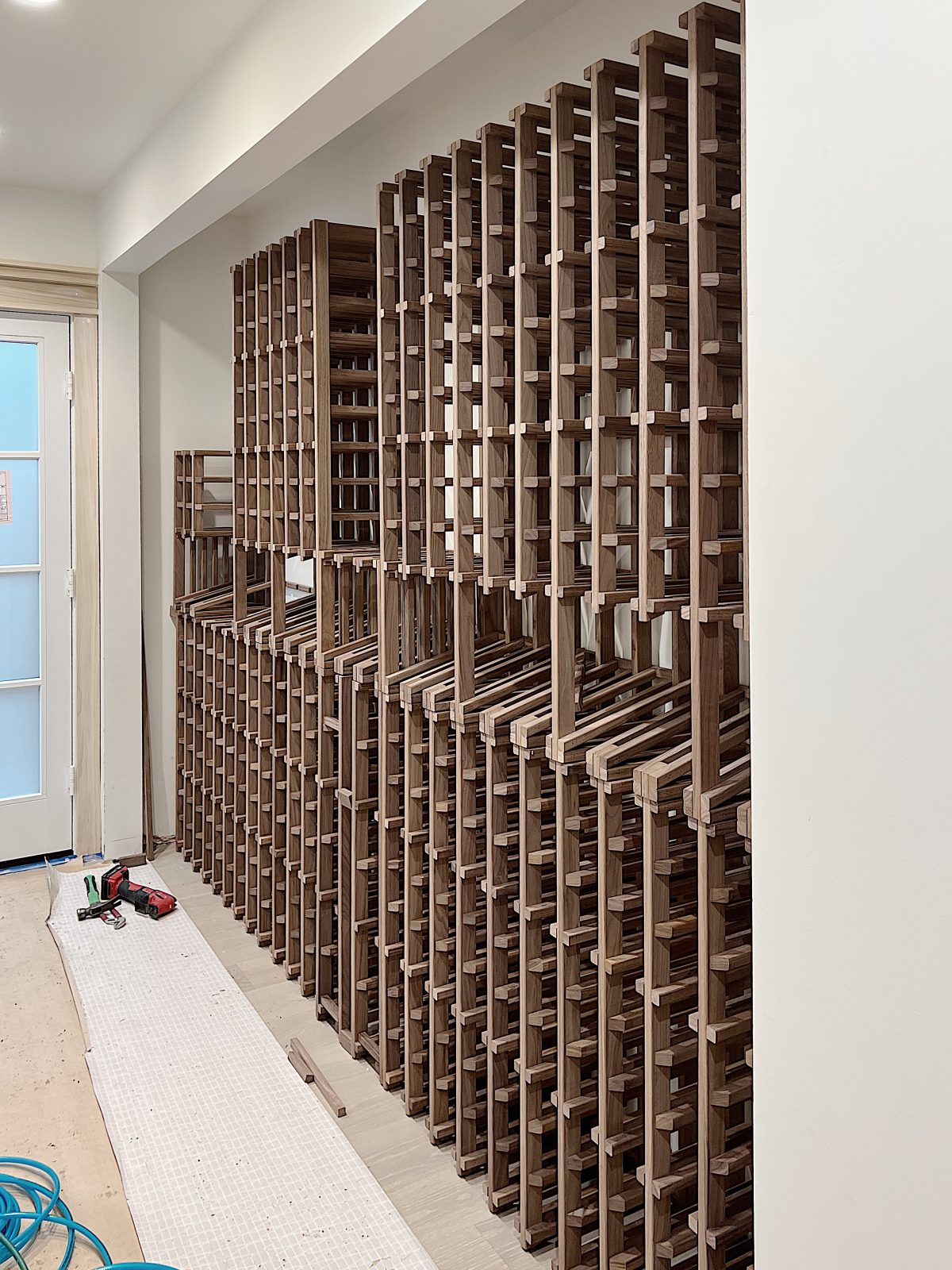 wine racks built in the hallway of a beach house