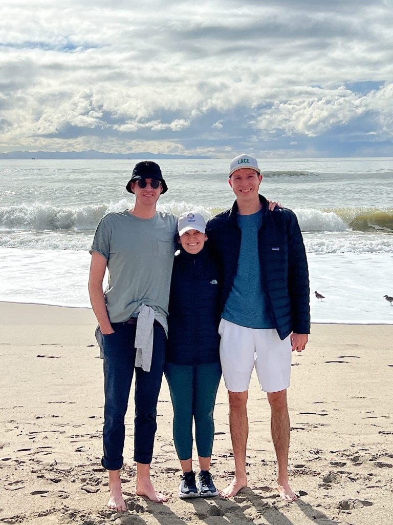 Matt, Ellie, and Michael standing on the beach