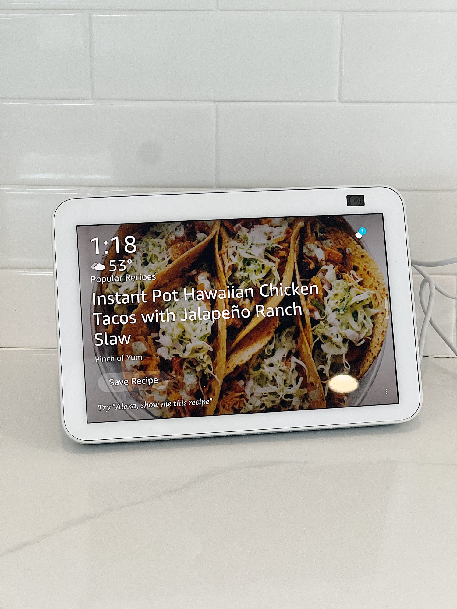 an Amazon Echo Show sitting on a white countertop