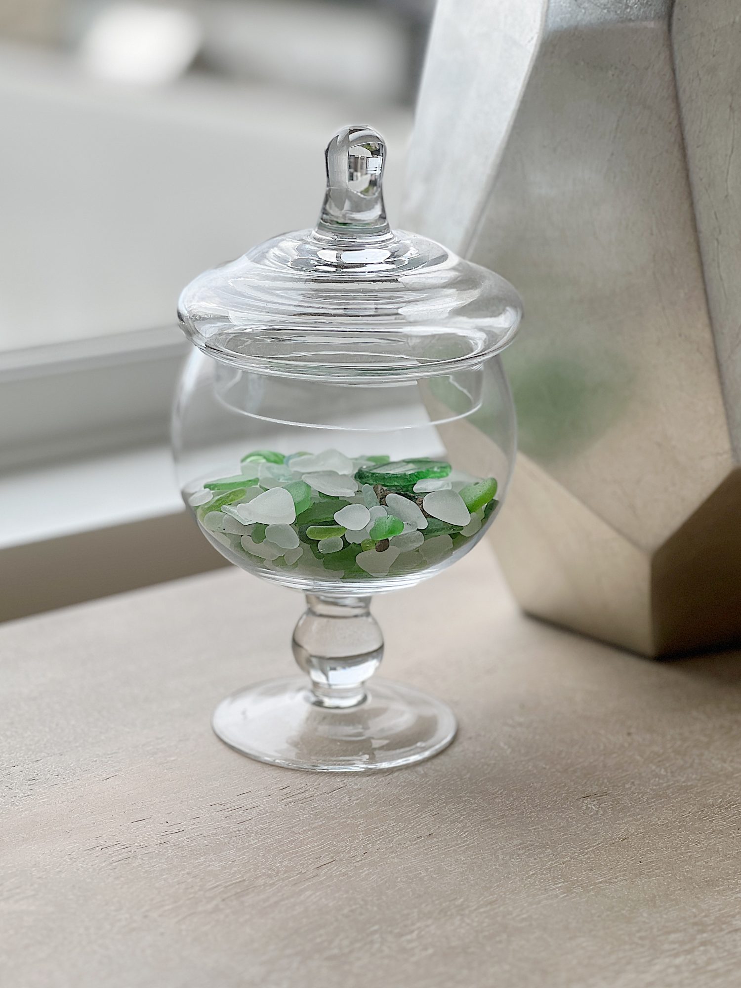 apothecary jar filles with sea glass