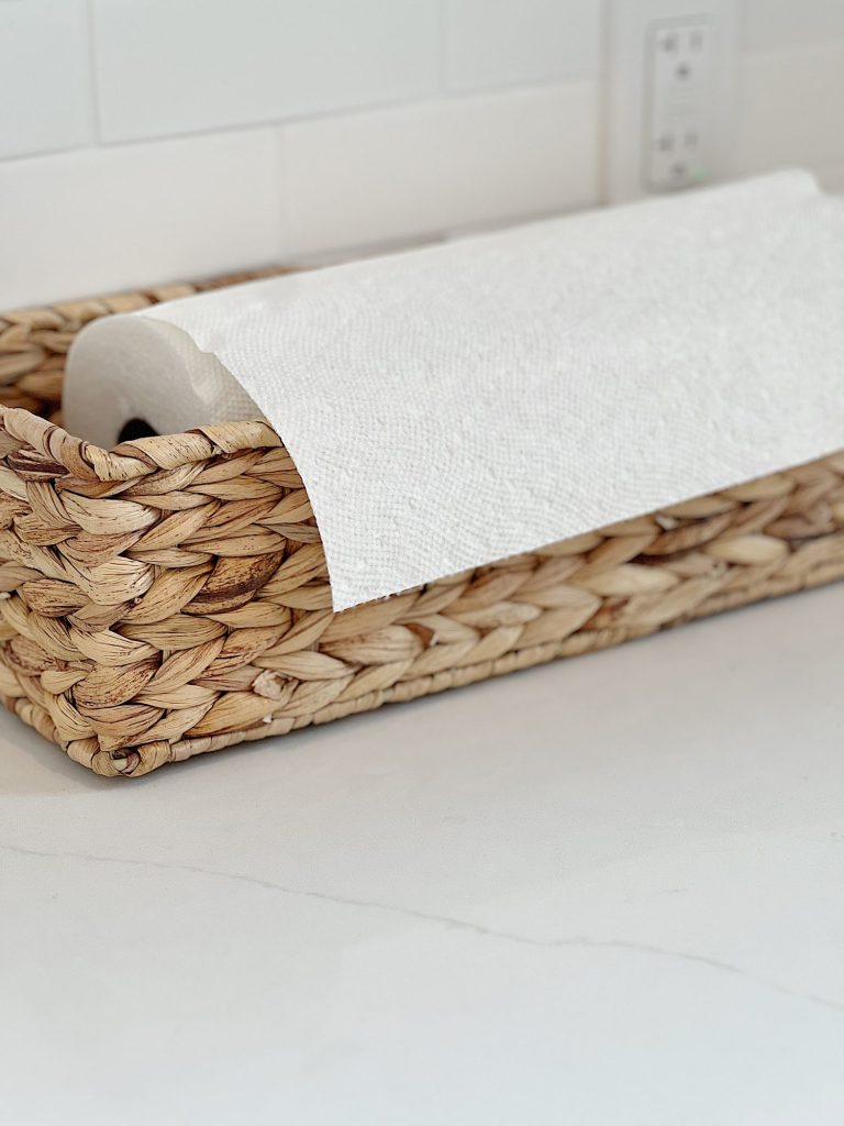 paper towels sitting in a wicker basket
