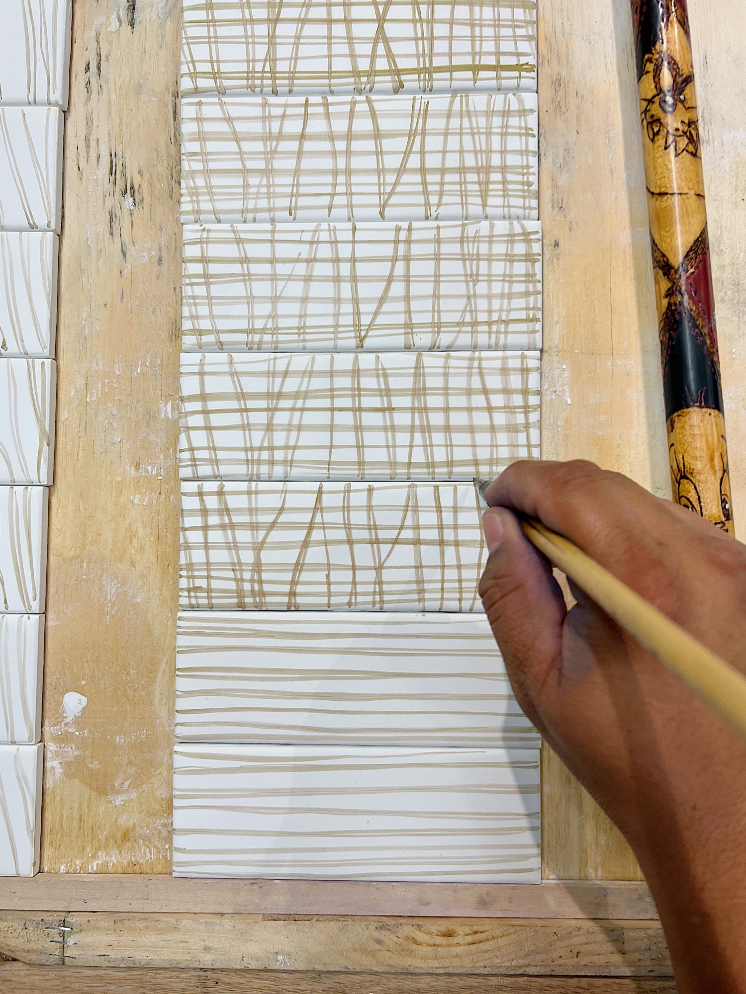 Watching the artist painting my design on to tiles at Mission Tile West