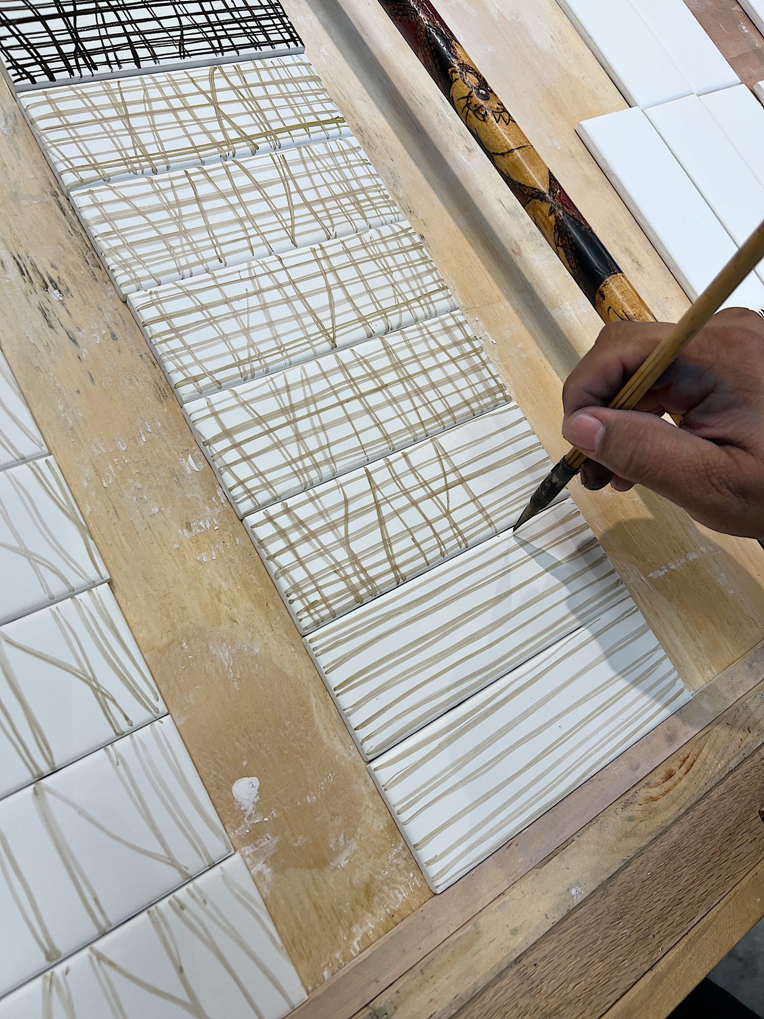 Watching the artist painting my design on to tiles at Mission Tile West