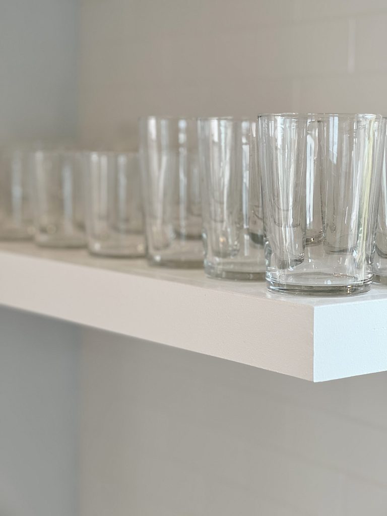 clear glasses on a white kitcehn shelf