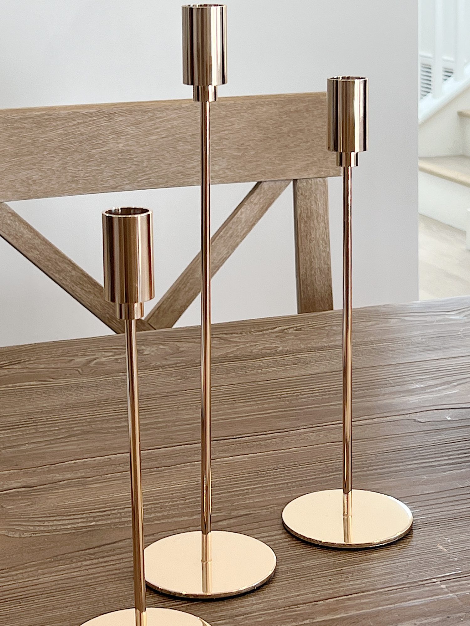 three gold candlesticks
