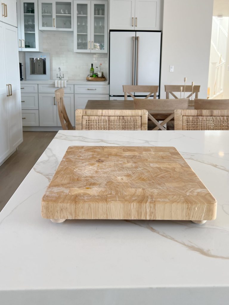 bamboo cutting board sitting on a quartz counter top