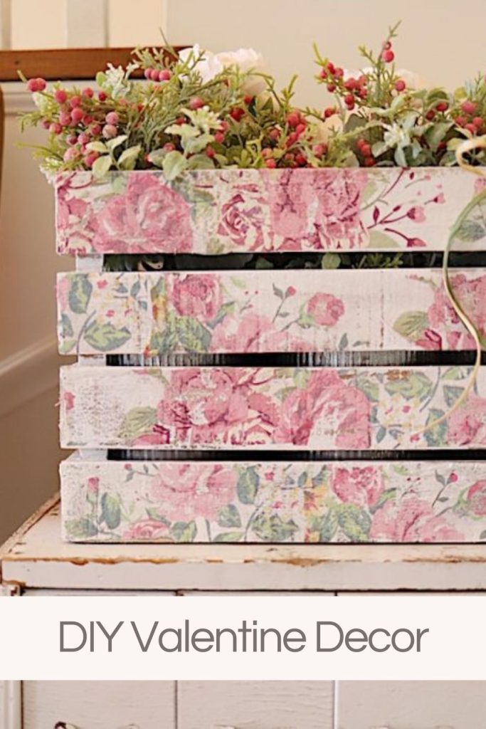 A wooden crate covered with floral paper napkins filled with faux flowers.