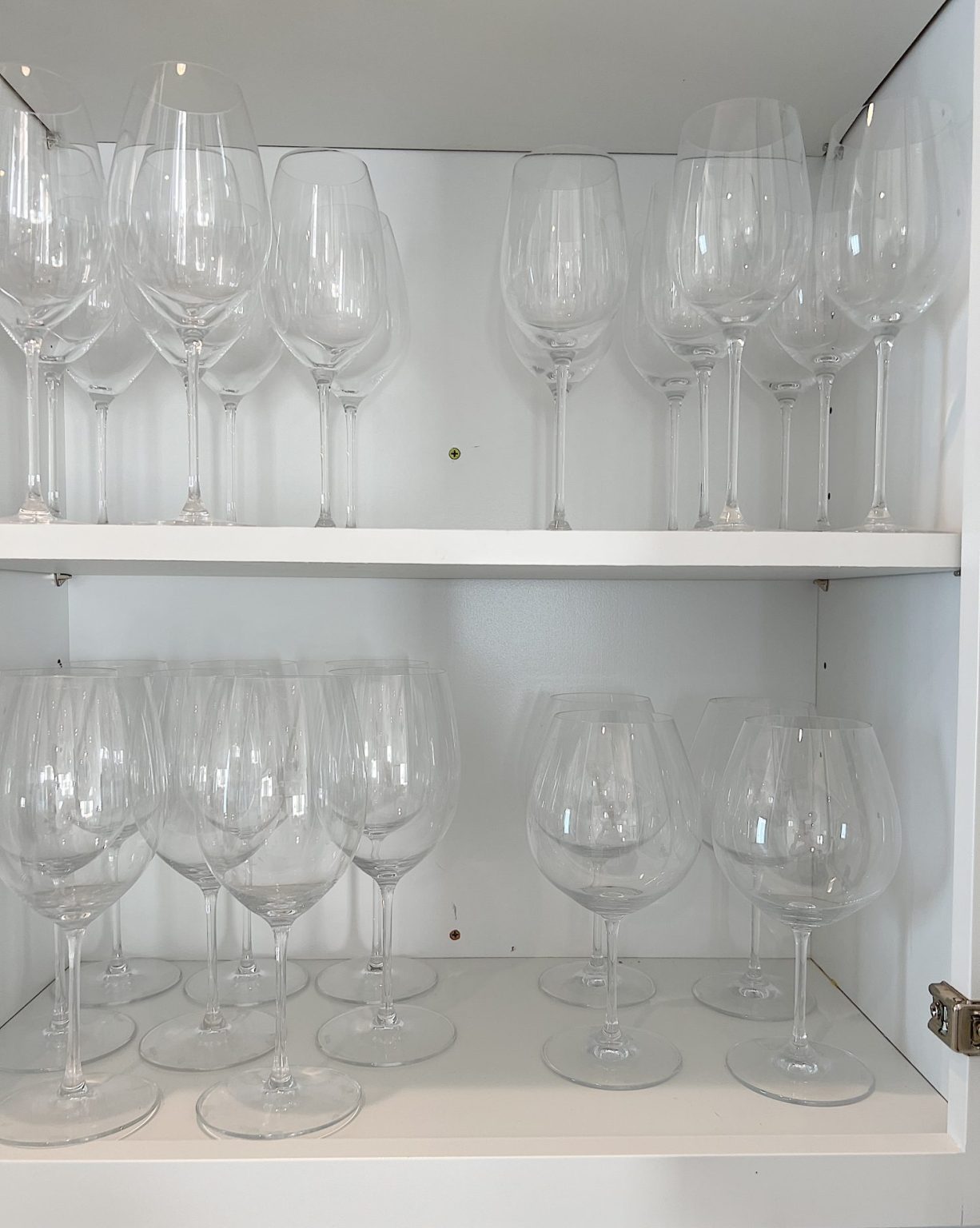 Shelves in the beverage area of the kitchen with Riedel wine glasses