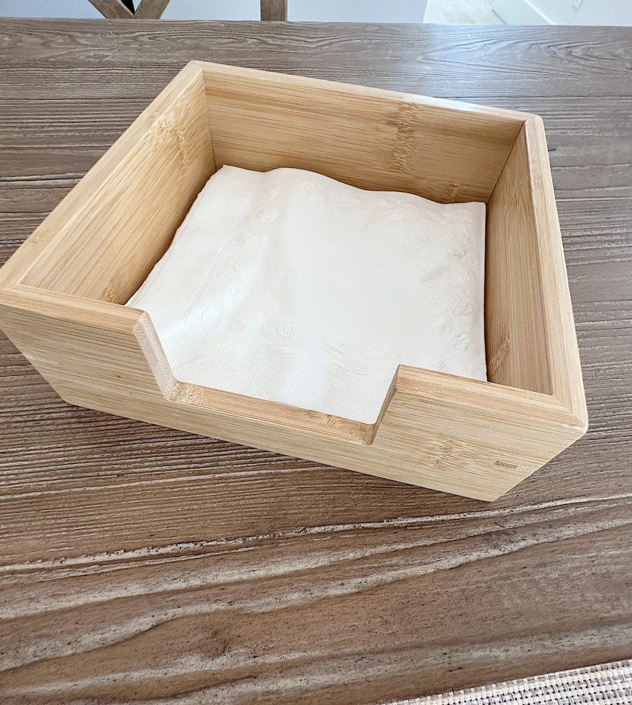 wood holder with white paper napkins