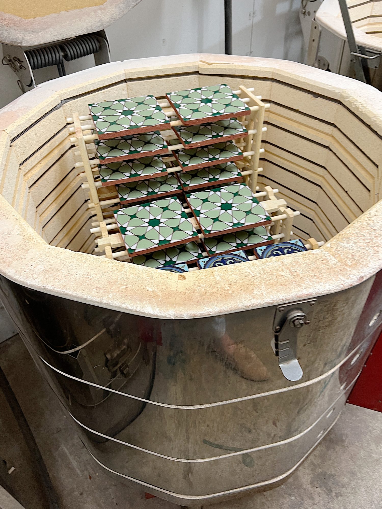 a pottery kiln with hand painted tiles inside