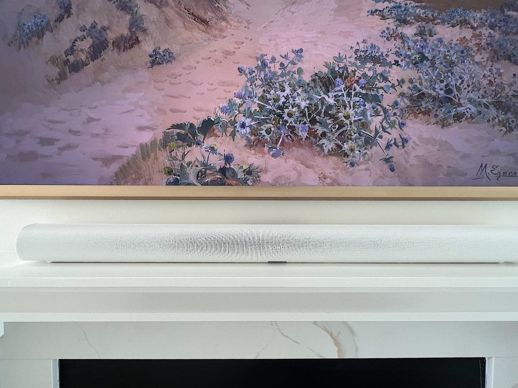 Sonos Arc sound booster sitting on top of fireplace