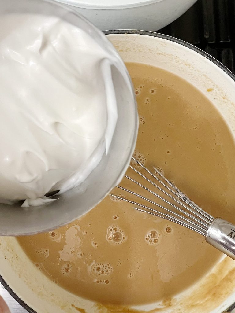 Adding coconut milk to a peanut butter soup