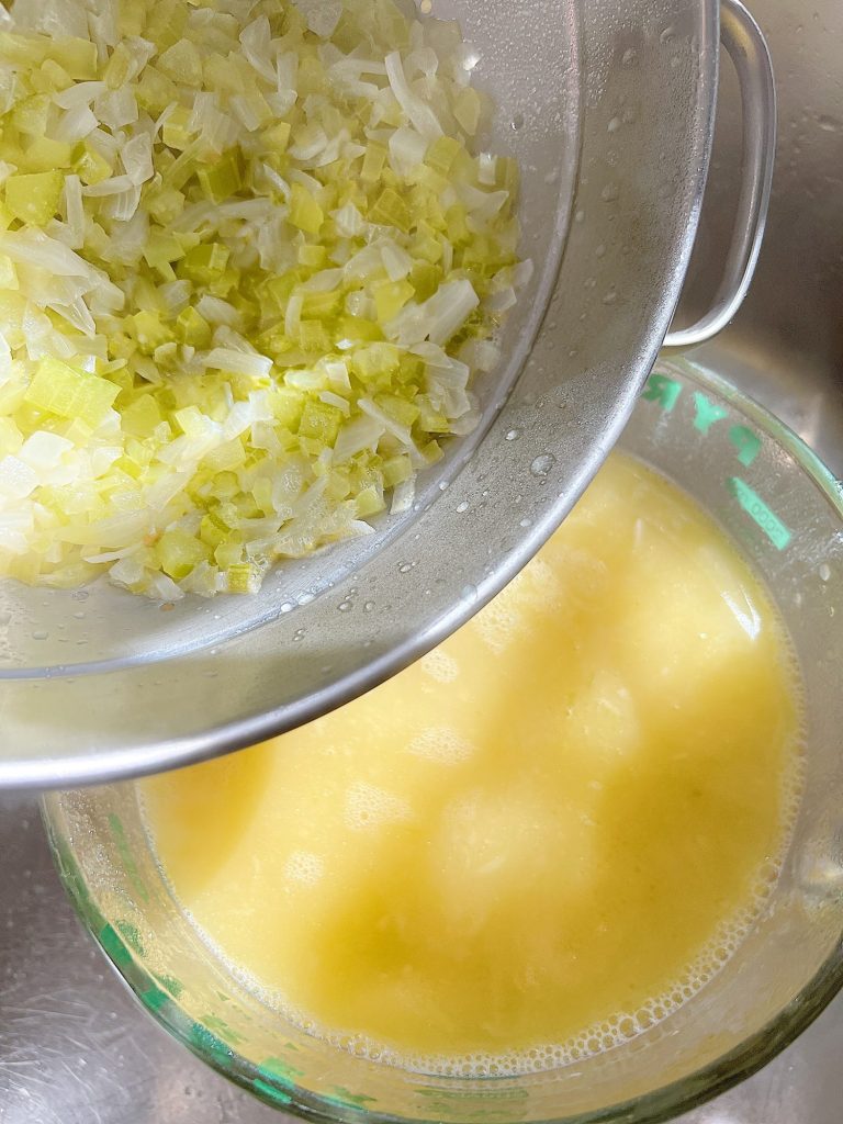 straining cooked onions, celery, and butter from a soup mixture.