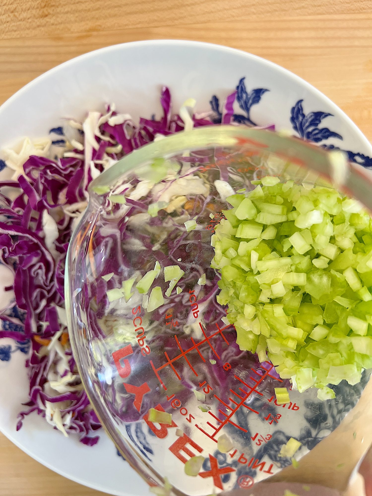 blue and white bowl and a peanut crunchy peanut coleslaw with a vinaigrette dressing.