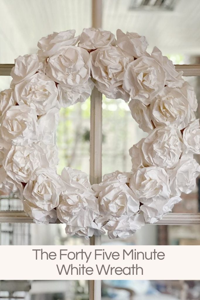 hanging white wreath made by foldomg white paper bags to look like flowers
