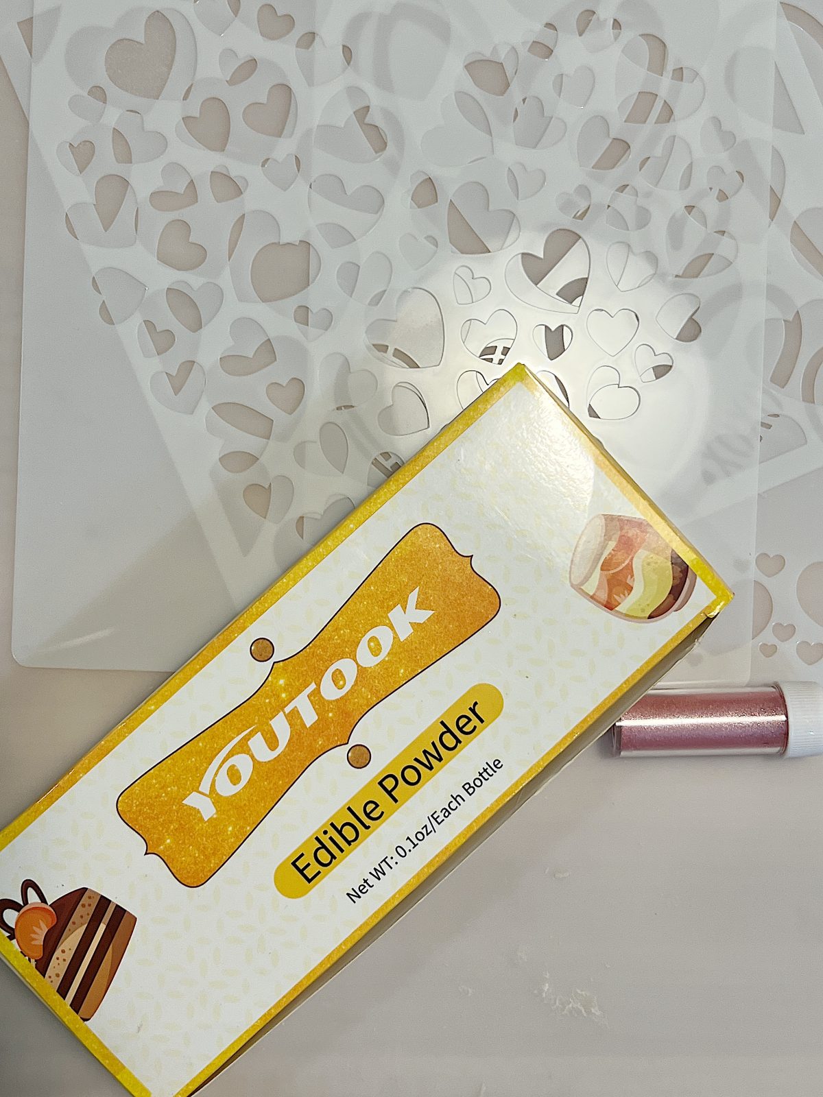 a box of edible powder and heart stencils