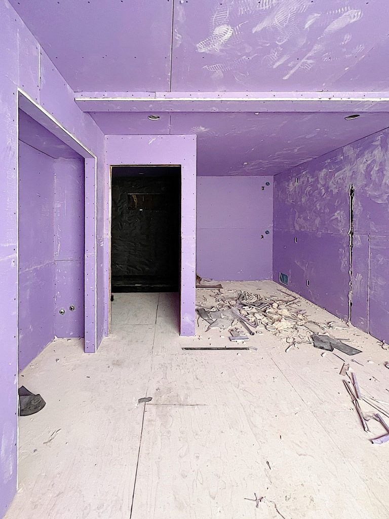Purple drywall in a bedroom